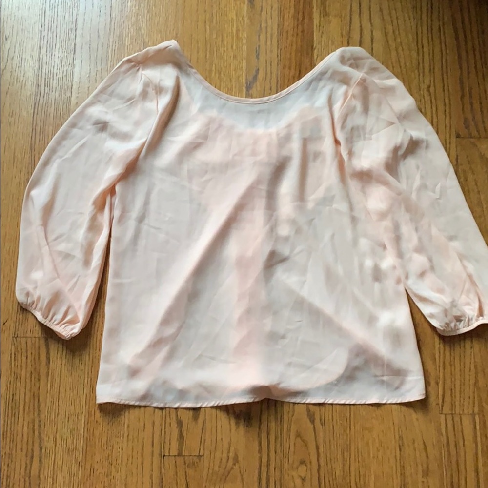 Sheer pint blouse with bow detailing in the back